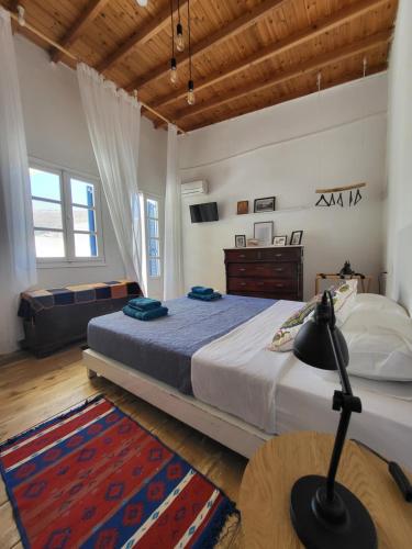 a bedroom with a bed and a dresser in it at Manolia House in Parikia