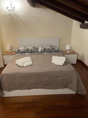 a bedroom with a bed with two pillows on it at la dimora del centro in Zafferana Etnea