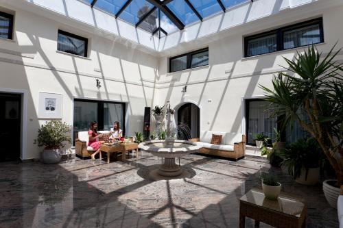 a courtyard with a fountain in the middle of a building at ApartHotel Vila Minka in Ljubljana