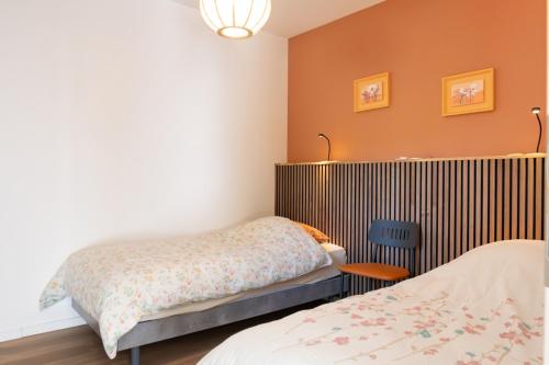 a bedroom with two beds and a radiator at Cocon d'Altitude avec Terrasse, Calme & Parking Privé in Orbey