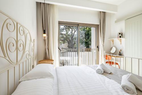 a bedroom with two white beds and a balcony at Villa Luna Bodrum, Özel Isıtmalı Havuzlu in Ortakent