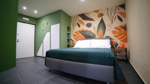 a bedroom with a bed with a painting on the wall at Didinas room in Potenza
