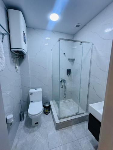 a bathroom with a shower and a toilet and a sink at FARIZ Hotel in Panjakent