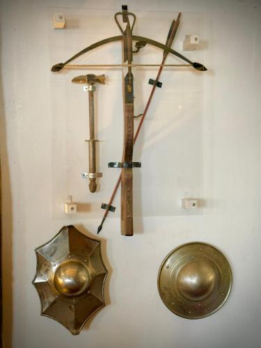 a display of different kinds of weapons on a wall at Cross Keys Hotel Chatteris in Chatteris