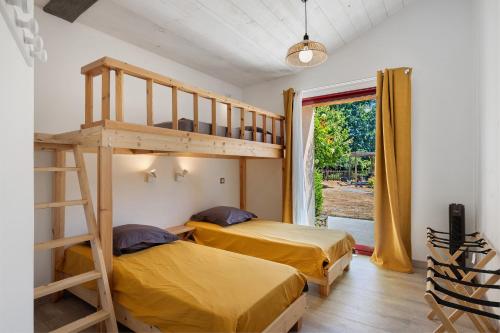 two beds in a room with a bunk bed at Le Cocon Vendéen Chambres D'hôtes in Saint-André-Goule-dʼOie