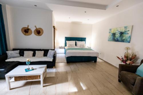 a living room with a bed and a couch at Apartman Karlina 100 m2 Terrace Garden in Šahy