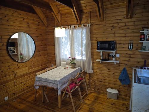 a dining room with a table in a log cabin at Ronit and Mario in Abirim