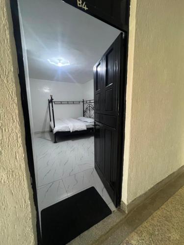 a door to a bedroom with a bed in a room at Rv delight suite in Nairobi