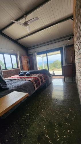 a bedroom with a bed in a room with windows at Kairos Vista in Sedgefield