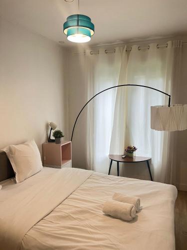 a bedroom with a bed with a towel on it at Appartement familial RDC in Boulogne-Billancourt
