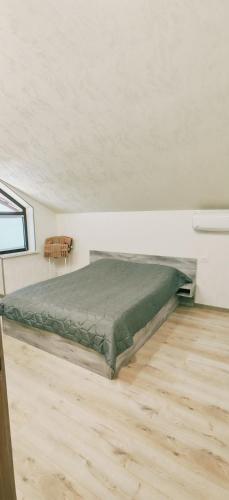 a bedroom with a bed in the middle of a room at Dreams House in Yengidzha