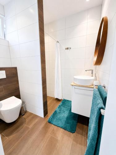 a bathroom with a sink and a toilet at Luxury Suites Oosterwold in Almere