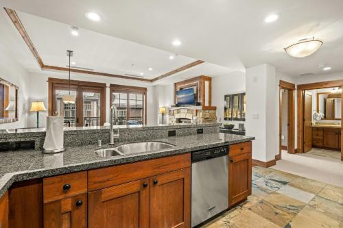 a kitchen with wooden cabinets and a sink at Northstar Resort by Vail Resorts in Truckee