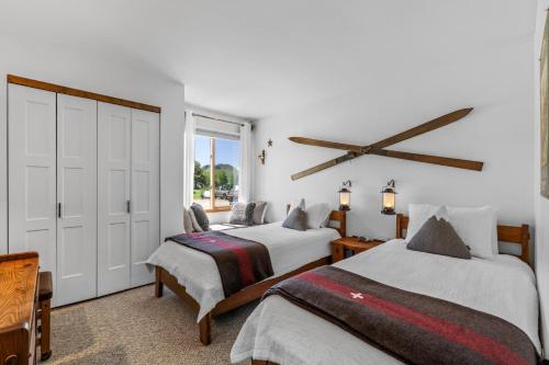 a bedroom with two beds and a large window at Chickadee in Clark