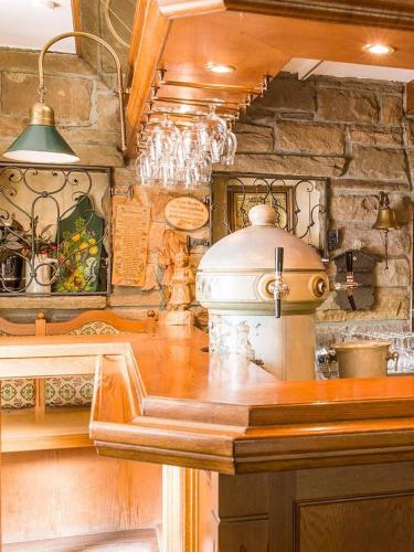a kitchen with a counter top and a stone wall at Burghotel Volmarstein in Wetter