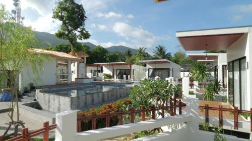 a villa with a swimming pool in a resort at Pukawa Hotel & Residence in Chaloklum