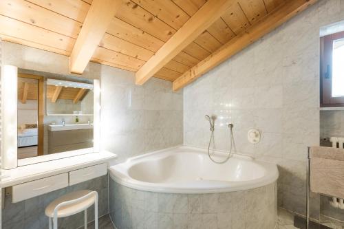 a bath tub in a bathroom with a wooden ceiling at Villa in Cermes