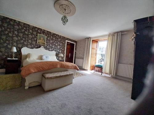 a bedroom with a large bed and a window at Fortedward Farm House in Thurles