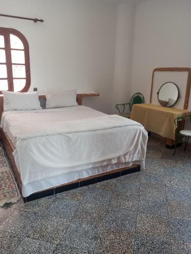 a bedroom with a bed and a mirror and a table at Amsa aqua villa in Tétouan