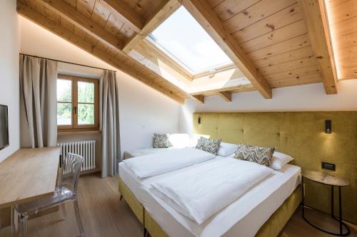 a bedroom with a large bed and a skylight at Villa in Cermes