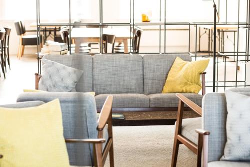 a living room with a couch and tables and chairs at Hotel Gullfoss in Haukadalur