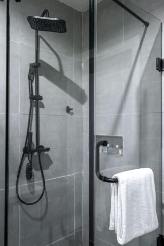 a shower with a glass door with a towel at Eterniti by Amber in Lagos