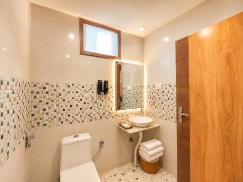 a bathroom with a toilet and a sink and a mirror at Durene Beach Resort - New Premium Resort In Baliapanda - Restaurant - Beach - Parking in Puri