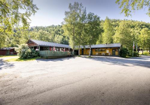 a building with a large driveway in front of it at Fauske Camping & Motel in Fauske