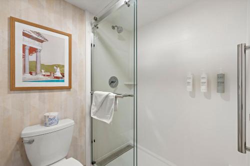 a bathroom with a toilet and a glass shower at Hampton Inn San Simeon Cambria in San Simeon