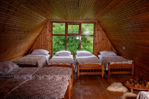 a group of beds in a room with a window at Bujtina Mitaj in Vermosh