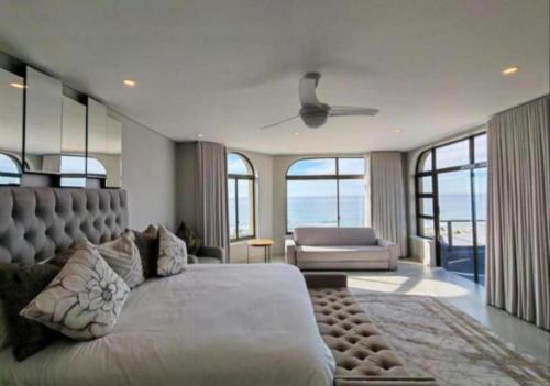 a bedroom with a large bed and a couch at Apartment 24 in Durban