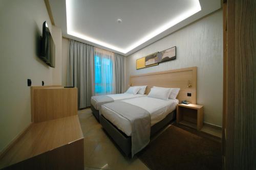 a hotel room with a bed and a television at Hotel BouBabel in Nador