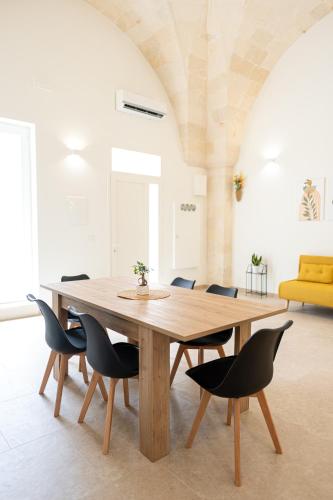 a wooden table in a room with chairs around it at Le Volte in Lizzano