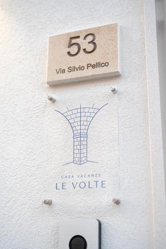 a sign on the side of a building with at Le Volte in Lizzano