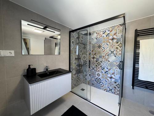 a bathroom with a shower with a sink and a mirror at Carimar, a mirada da ría in Boiro