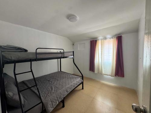 a room with two bunk beds and a window at Jabs cabin 2 in Angeles