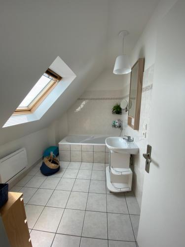 a bathroom with a sink and a bath tub at tyklan in Bénodet