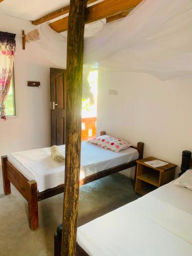 a bedroom with two beds in a room at Paje lounge in Paje