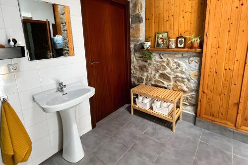 a bathroom with a sink and a stone wall at Sallobante Aterpetxea - Casa in Mechicas