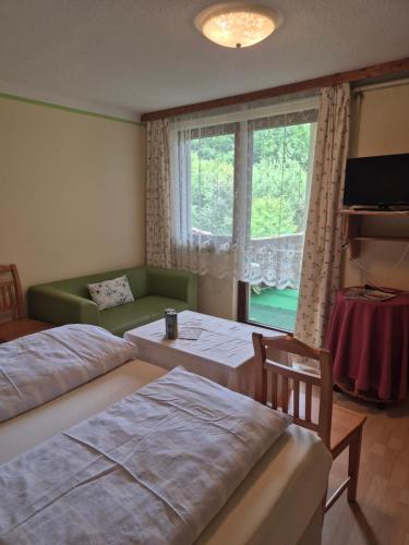 a living room with two beds and a window at Landhaus Ingrid in Loich
