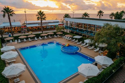 an aerial view of a resort swimming pool with umbrellas at Era Palace Gonio in Kvariati