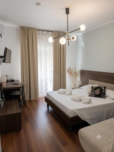 a bedroom with a bed and a desk and a bed sidx sidx sidx at Guest House Al Viale in Caltagirone