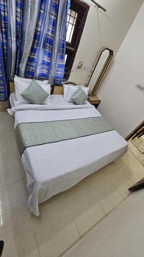 two beds sitting next to each other in a room at Value Stays By Amisha Palace in Jaipur