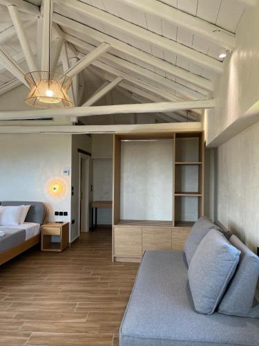 a large living room with a couch and a table at TERPOU StoneHouse & Suites in Volos