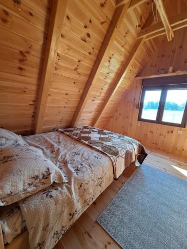 a bedroom with a bed in a log cabin at Koliba SAN in Žabljak