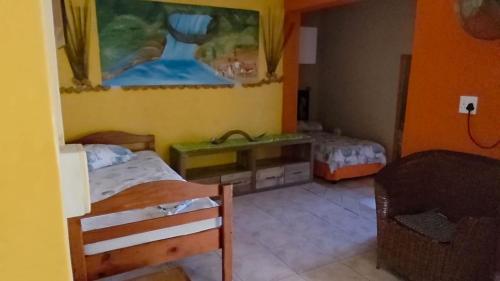 a small bedroom with two beds and a couch at Mizpah Self Catering Accommodation in Walvis Bay