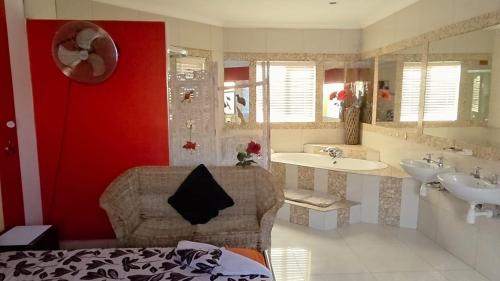 a bathroom with two sinks and a red wall at Mizpah Self Catering Accommodation in Walvis Bay