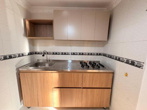 a kitchen with a sink and a stove at La casa de Fefa in Ríohacha