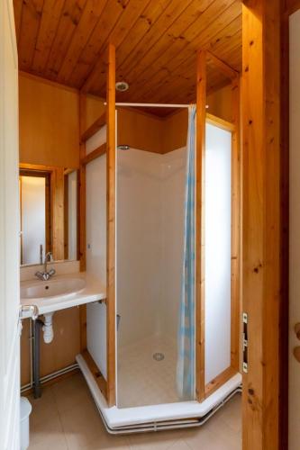 a bathroom with a shower and a sink at Camping l'Estela sur le GR70 in Le Monastier sur Gazeille