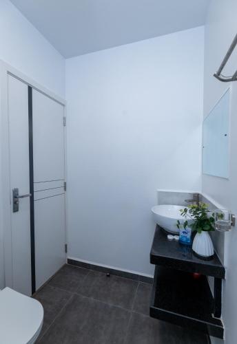 a bathroom with a sink and a toilet at 1 bedroom unit with a sunrise view in Tatu City